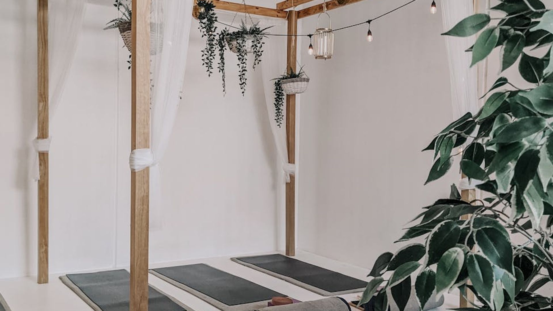 Atmospheric yoga studio with soft blue lighting and mats.