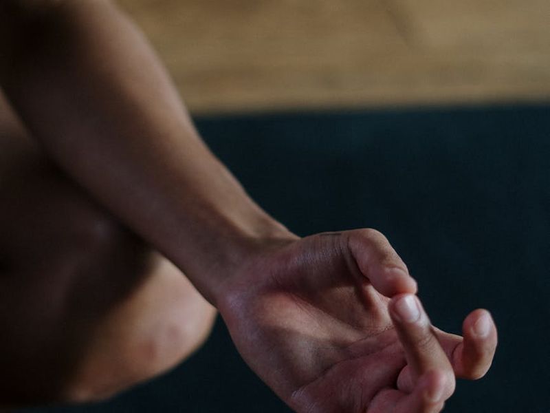 Close-up of hands in a mudra position during yoga practice.